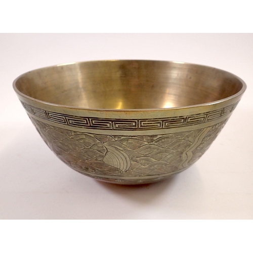 751 - A Chinese brass bowl decorated dragon and waves, cast mark to base, 24cm