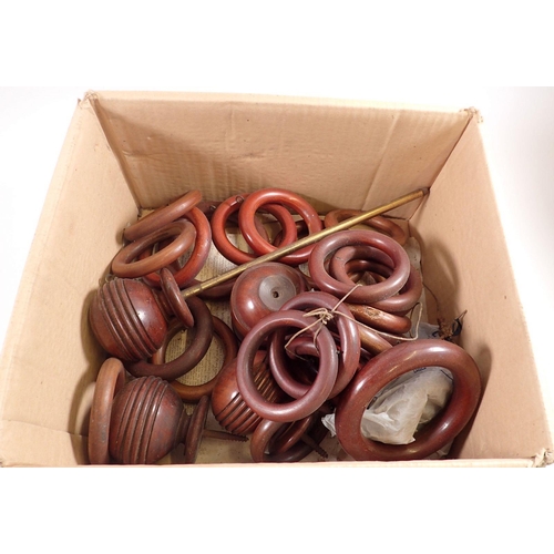 791 - A box of 19th century wooden curtain rings and turned finials