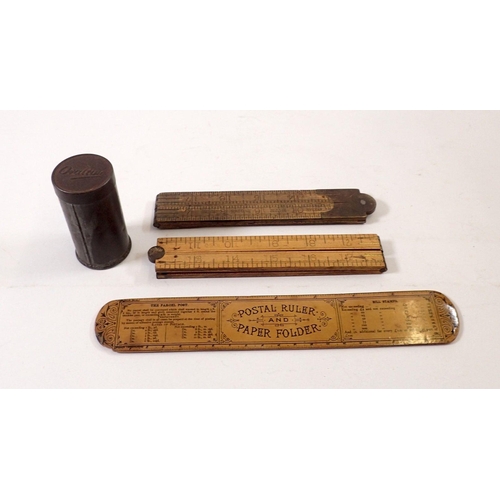 793A - A Barmouth Postal Ruler, two wooden folding rulers and an Ovaltine travel tin