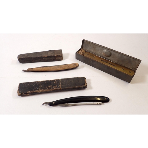 794A - A brass spirit level and two cut throat razors in metal box