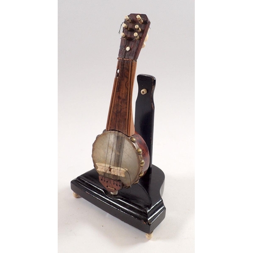 796 - A miniature walnut model of a banjo with bone mounts, 19cm tall