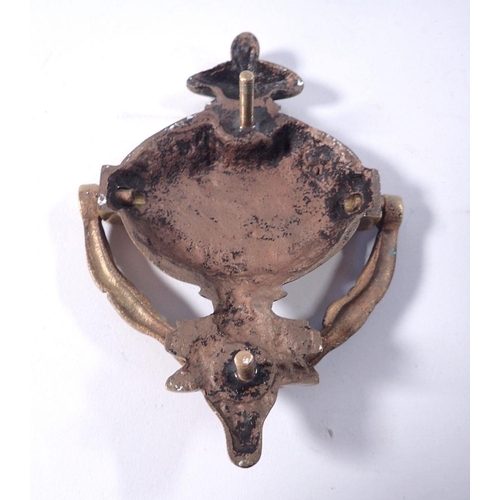 797 - A brass rams head door knocker, 15cm tall