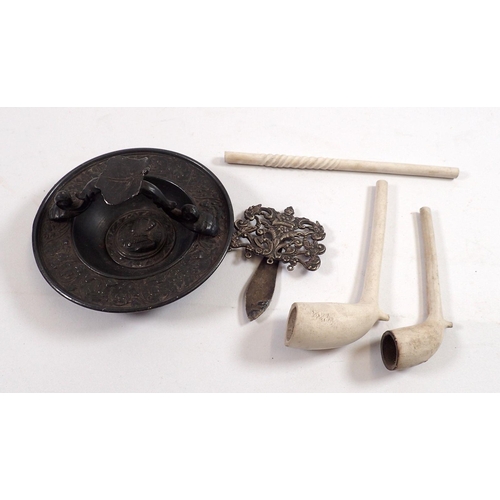 798 - A continental cast metal ashtray, three clay pipes and a silver plated chatelaine top