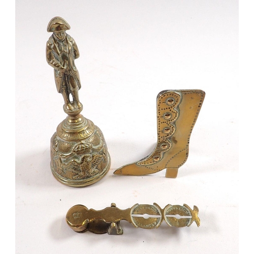 799A - A brass sovereign scale, brass ladies boot on easel stand and a brass bell featuring Napoleon handle