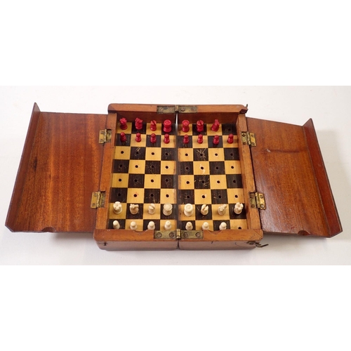 800A - A mahogany cased travelling chess set with bone pieces (2 missing), circa 1900