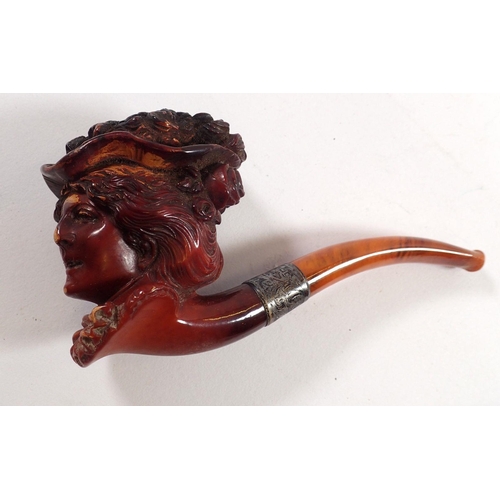 802 - A 19th century Meerschaum pipe in the form of a ladies head with silver collar and amber mouthpiece,... 