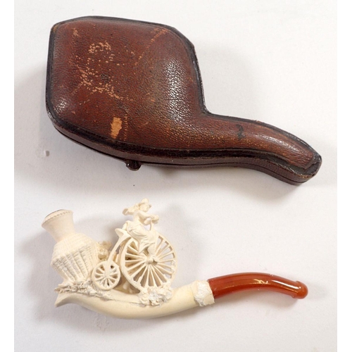 804 - A Meerschaum pipe showing woman on a penny farthing bicycle, with amber mouthpiece, 10cm x 5cm appro... 