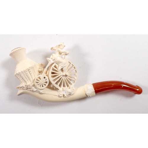 804 - A Meerschaum pipe showing woman on a penny farthing bicycle, with amber mouthpiece, 10cm x 5cm appro... 