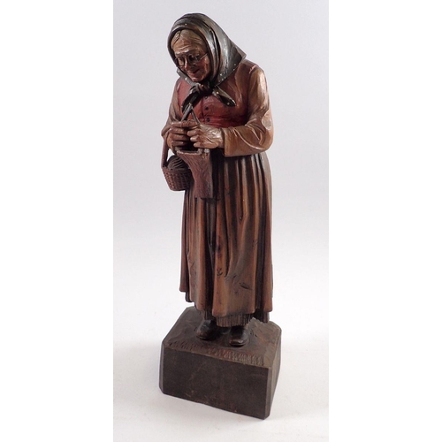 822 - A Black Forest carved figure of a woman 35cm tall