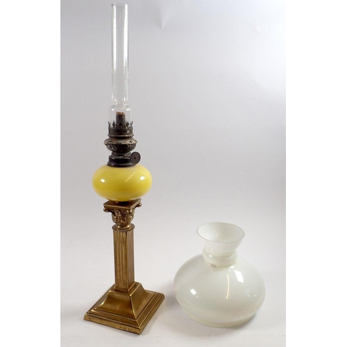 837 - A Victorian small brass column oil lamp with yellow glass reservoir and white shade, column 20cm tal... 