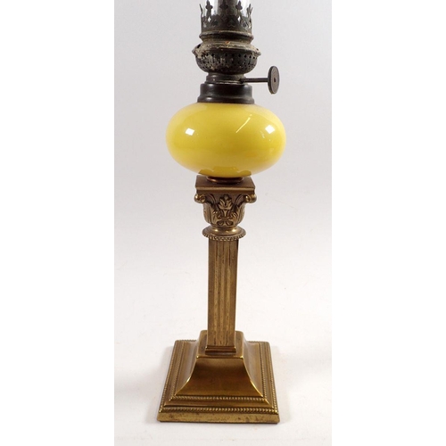 837 - A Victorian small brass column oil lamp with yellow glass reservoir and white shade, column 20cm tal... 