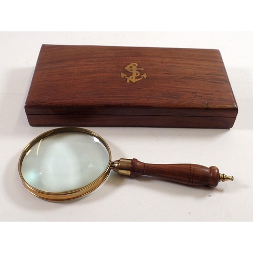 841 - A brass magnifying glass in wooden box