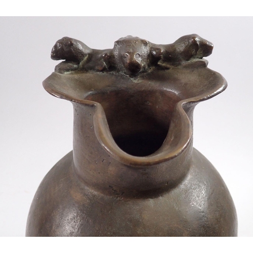 867 - A 19th century bronze jug in Roman style with lions head and anthemon leaf handle, 25cm tall