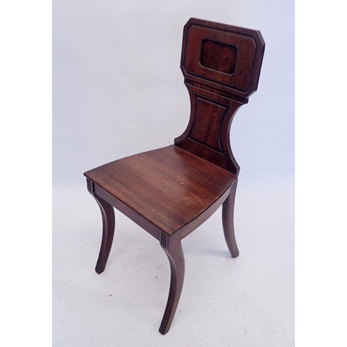 881 - A Georgian mahogany hall chair with rectangular panel back and sabre supports