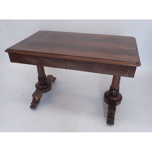 882 - A Victorian rosewood library table with two frieze drawers raised on end column supports and paw fee... 