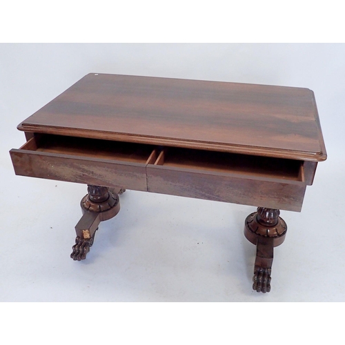 882 - A Victorian rosewood library table with two frieze drawers raised on end column supports and paw fee... 