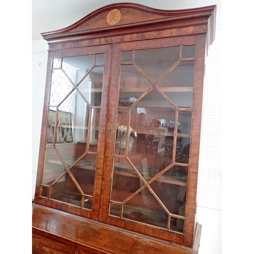 885 - An early 19th century mahogany secretaire bookcase, the arch to inlaid cornice over pair of astragal... 