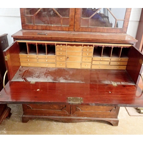 885 - An early 19th century mahogany secretaire bookcase, the arch to inlaid cornice over pair of astragal... 