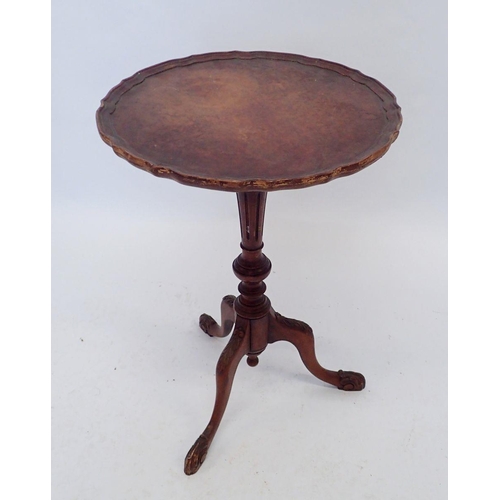 939 - A walnut wine table with frilled edge and triple paw supports, 40cm diameter