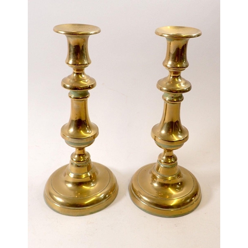 941 - A pair of brass baluster candlesticks, 24.5cm tall