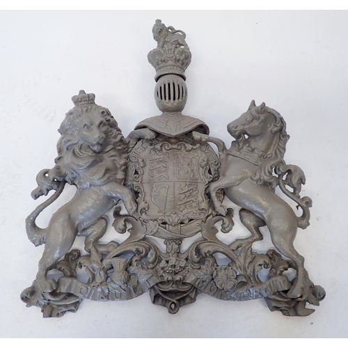 942 - A large cast iron over lintel Royal heraldic crest with lion and unicorn, now painted grey 58 x 55cm