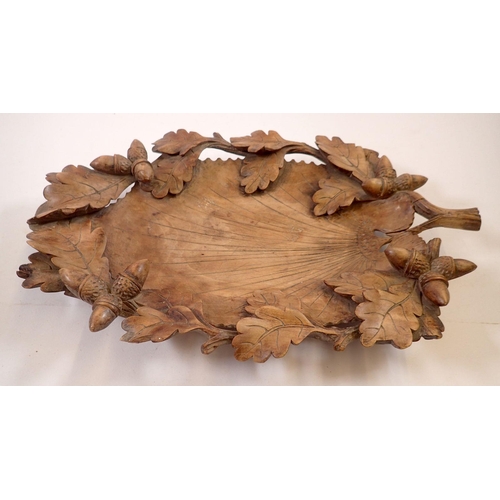 965 - A 19th century Black Forest carved wooden leaf form nut bowl with oak and acorn border, 39 x 26cm