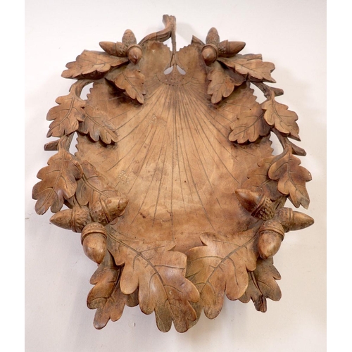 965 - A 19th century Black Forest carved wooden leaf form nut bowl with oak and acorn border, 39 x 26cm