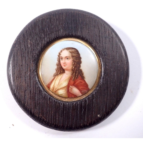 971 - A 19th century painted porcelain miniature of a woman in oak frame, overall size 10.5cm diameter