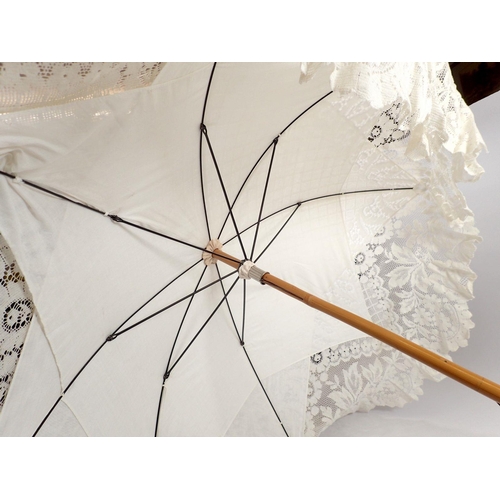 993 - An Edwardian style white lace wedding parasol with bamboo handle