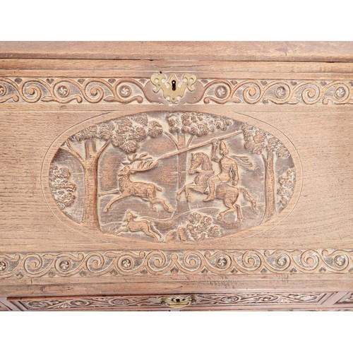 933 - An early 18th century bureau with all over finely carved decoration including hunting scene, foliage... 