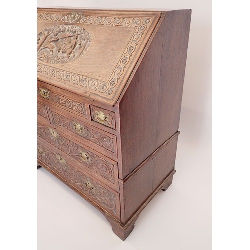 933 - An early 18th century bureau with all over finely carved decoration including hunting scene, foliage... 