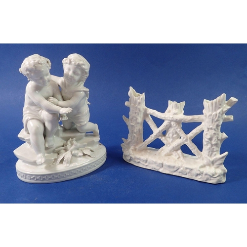 104 - A Victorian white porcelain cherub group and a tree trunk posy pot, 16cm