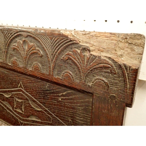 1055 - A 17th century oak four panel settle with carved decoration and dated 1661, 121cm x 185cm wide x 55c... 