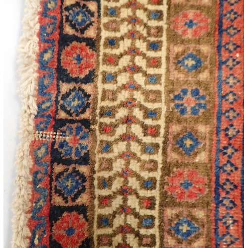 1091 - A large Persian rug with geometric and floral design on a pink ground, 214 x 162cm