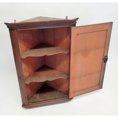 1103 - A small Georgian oak corner cabinet with panelled door and brass butterfly hinges, 93cm tall