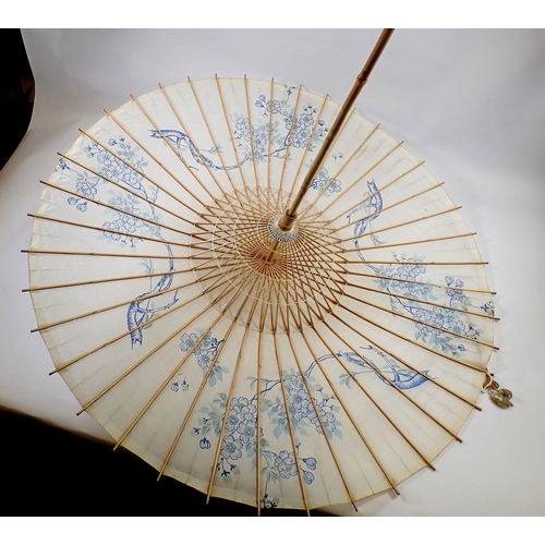 1228 - A Japanese bamboo and silk parasol painted blue flowers, 86cm