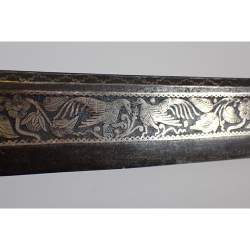 1232 - An antique Burmese sword or dha, the singe edge carved blade with foliage, floral and animal decorat... 