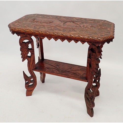 1234 - An ornately carved Indian two tier occasional table with lion and elephant decoration, 69 x 37cm