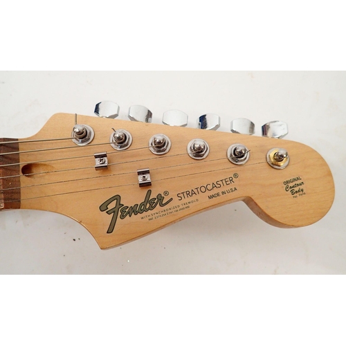 1236 - A Fender Stratocaster style electric guitar with wooden body, 98cm long