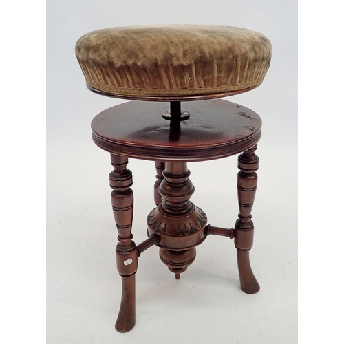 1242 - A Victorian mahogany revolving piano stool on turned and reeded supports