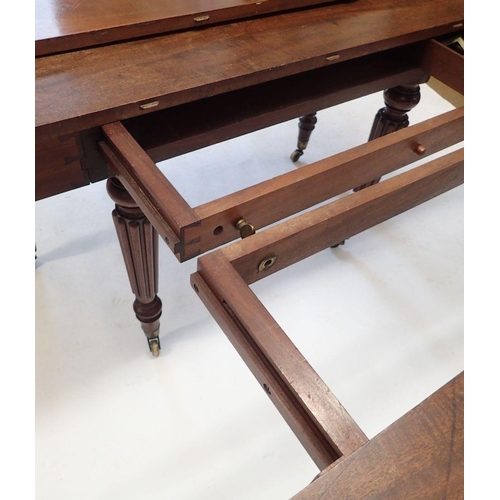 1260 - A Victorian Gillow's Style  large mahogany dining table with three extending leaves, and slide out m... 