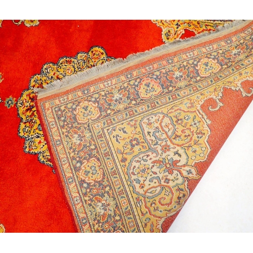 1280 - A Persian style rug with medallion design on iron red ground 195 x 135cm