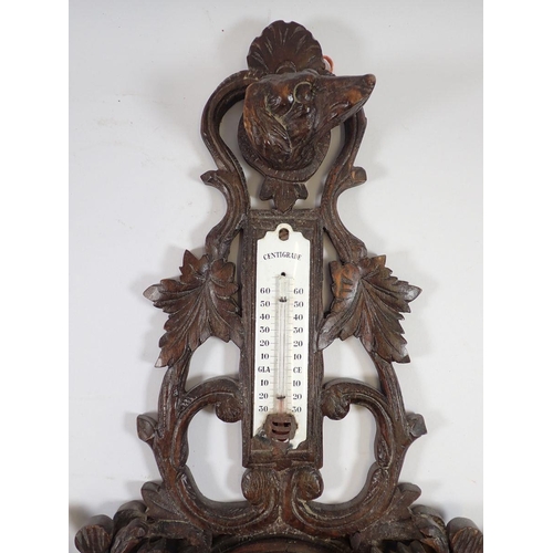 1282 - A Black Forrest wood barometer/thermometer carved game and gun dog, 58cm tall