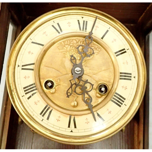 1283 - A Vienna style mahogany wall clock with Art Nouveau embossed dial, pendulum and key, 63cm