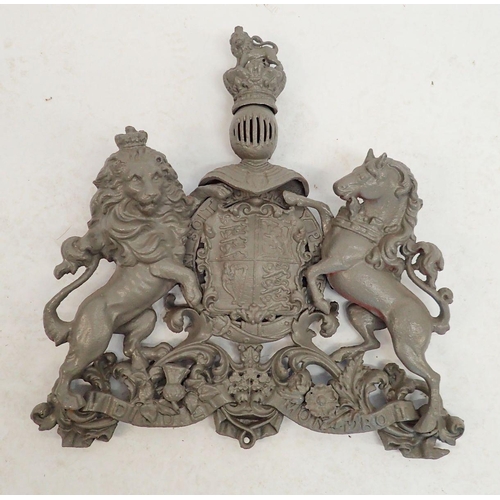 1310 - A large cast iron over lintel Royal Heraldic crest with lion and unicorn, now painted grey, 58 x 55c... 