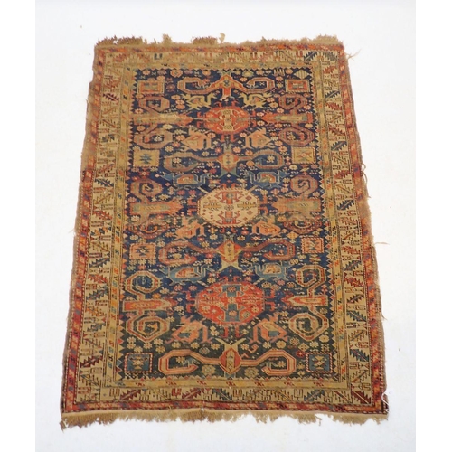 1313 - An antique Turkoman rug with multiple guls on a blue ground - in poor condition, 154 x 115cm