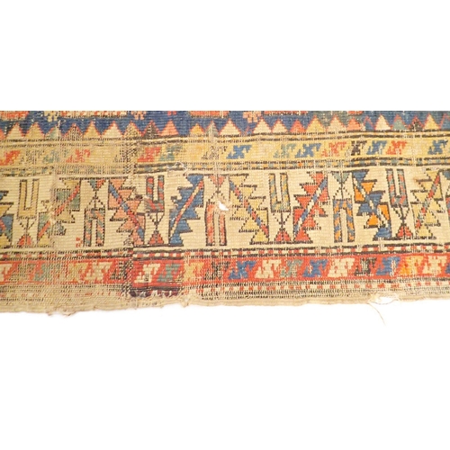 1313 - An antique Turkoman rug with multiple guls on a blue ground - in poor condition, 154 x 115cm