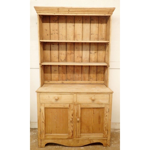 1314 - A 19th century large pine dresser with open shelves above two drawers and two cupboard doors, 117cm ... 