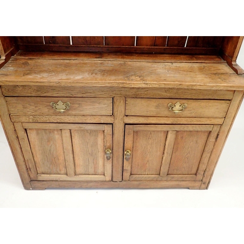 1315 - An 18th century elm and pine Welsh dresser with three tier back over two short drawers and two panel... 