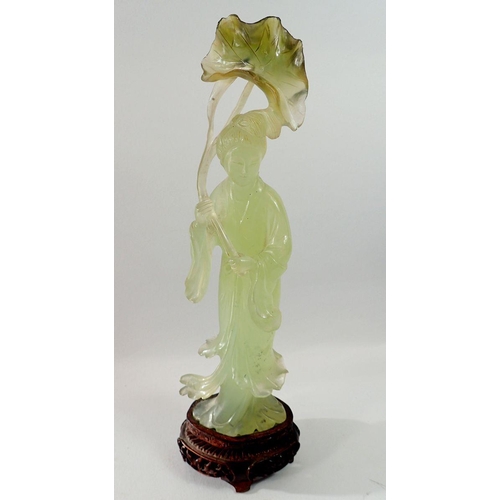 1334 - An early 20th century Chinese carved jade figure of a lady holding a lily leaf on carved stand, 26.5... 